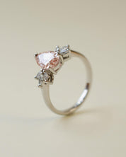 Pink pear cut lab-grown diamond ring with marquise diamond side stones
