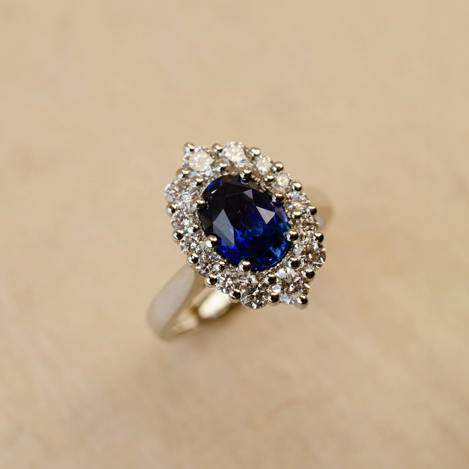 Platinum blue sapphire cluster style ring with white diamonds