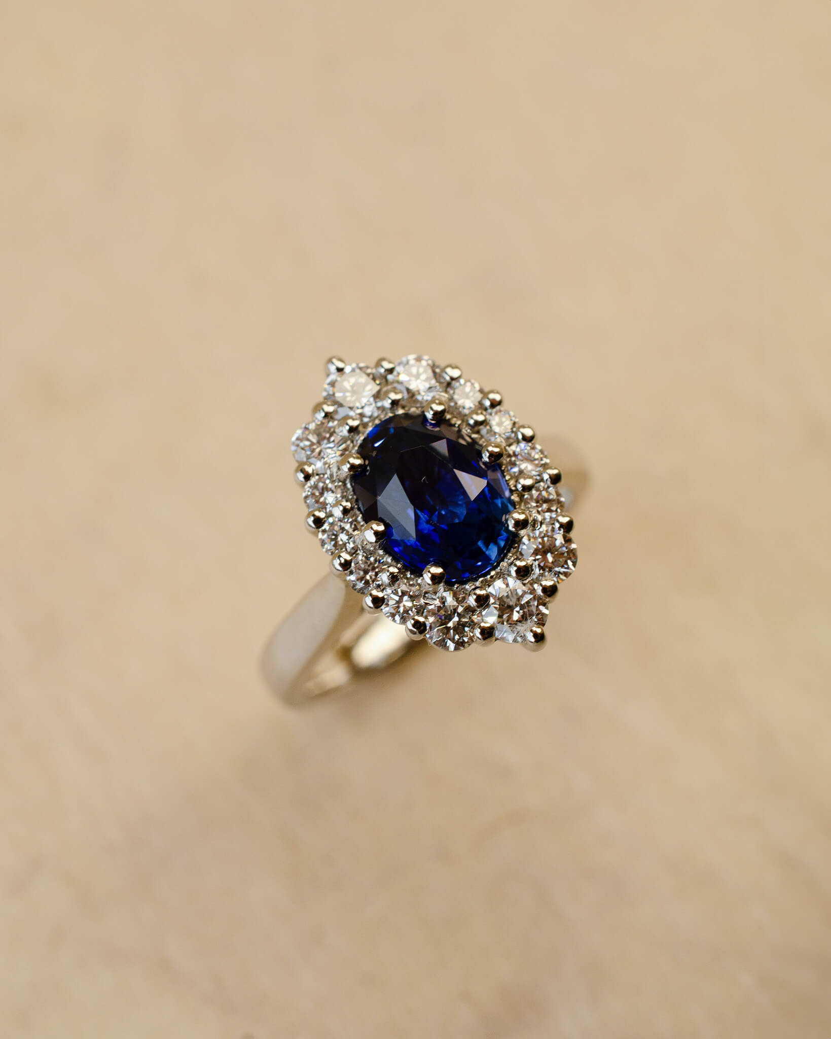 Platinum blue sapphire cluster style ring with white diamonds