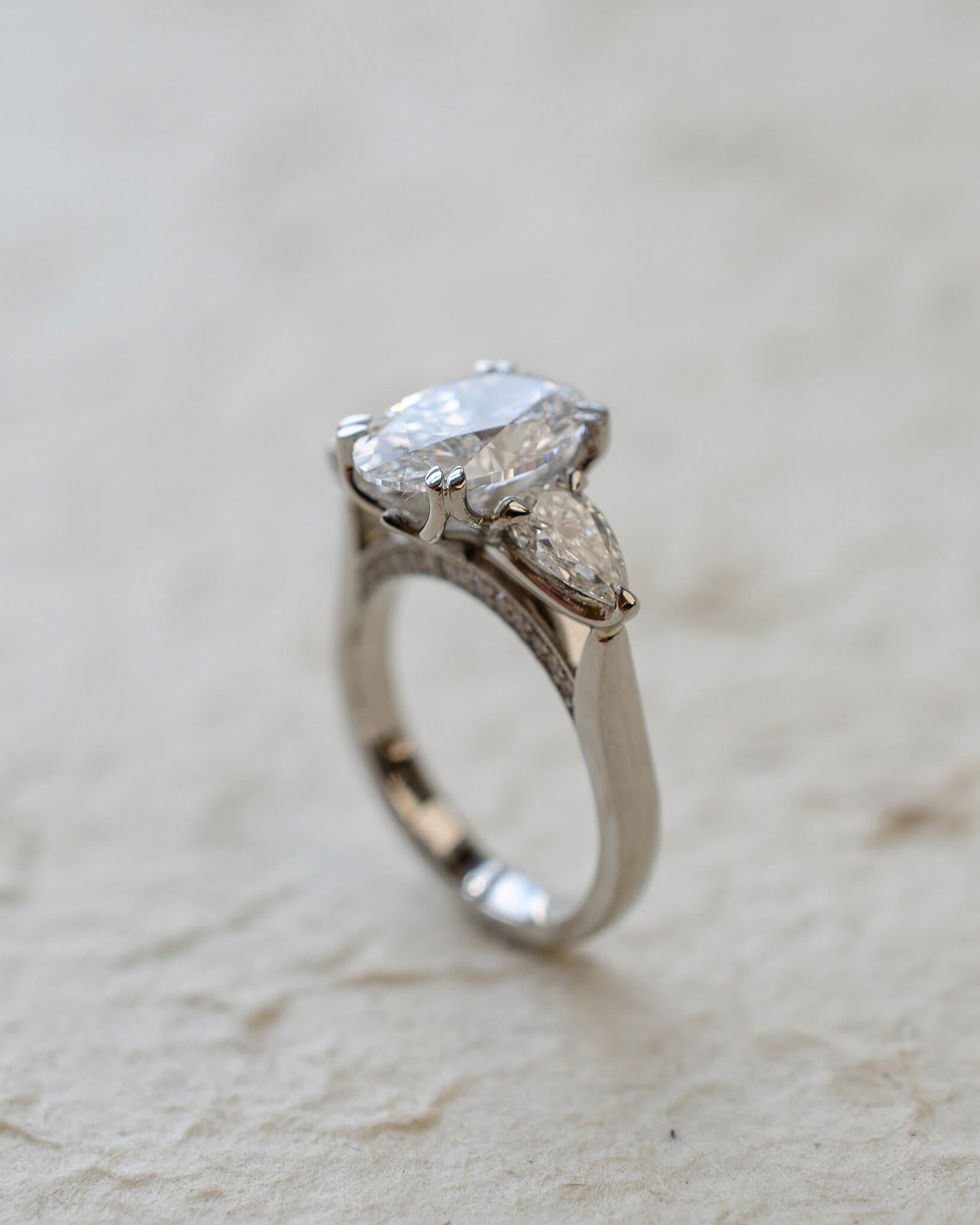 platinum trilogy ring with oval and pear lab-grown diamonds