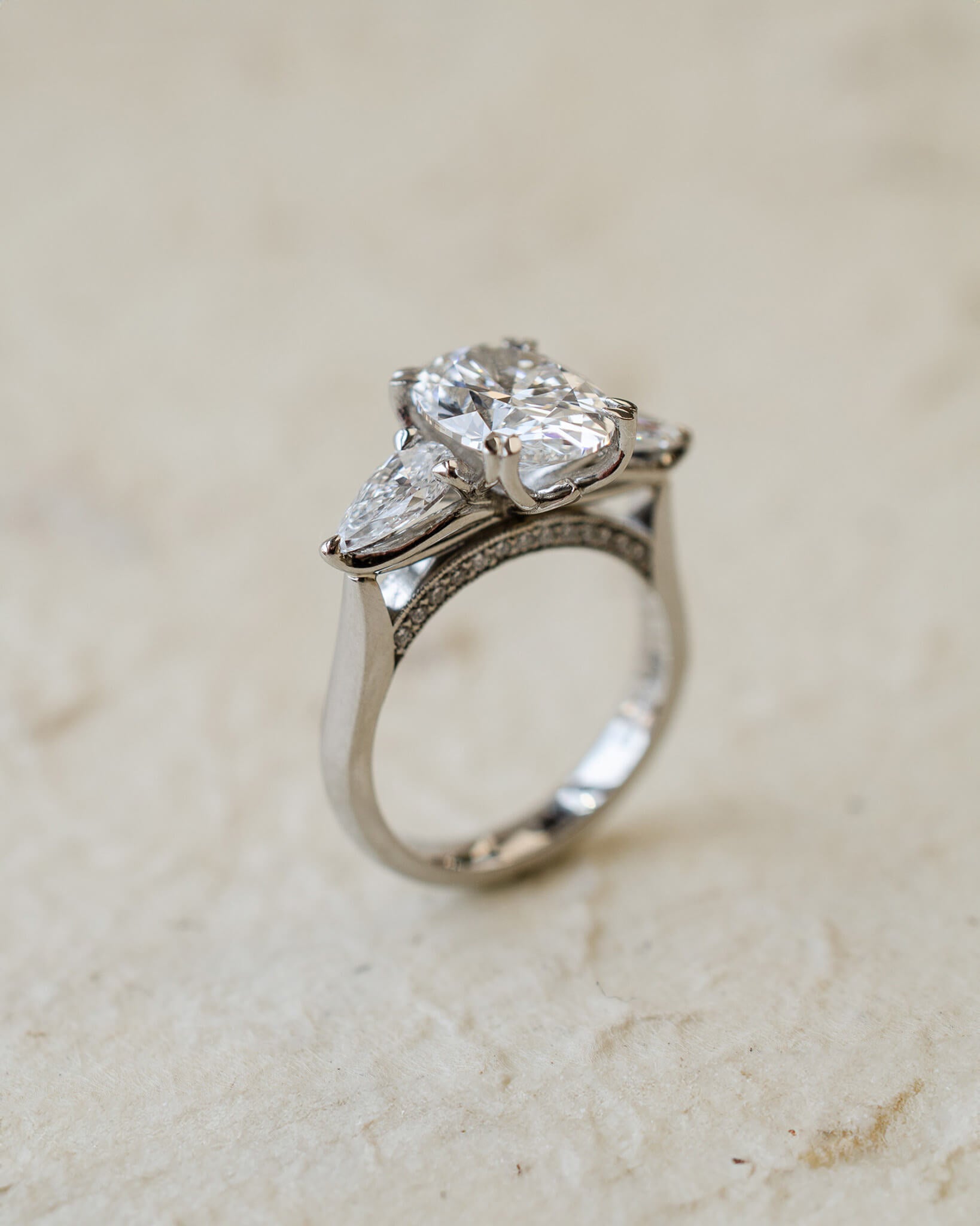 platinum trilogy ring with oval and pear lab-grown diamonds