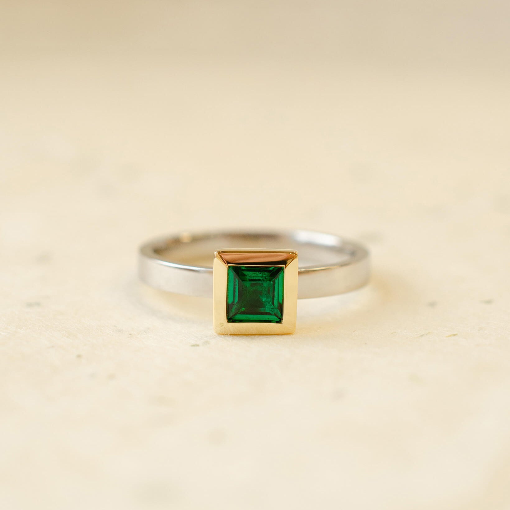 platinum and 18ct yellow gold ring with princess cut emerald
