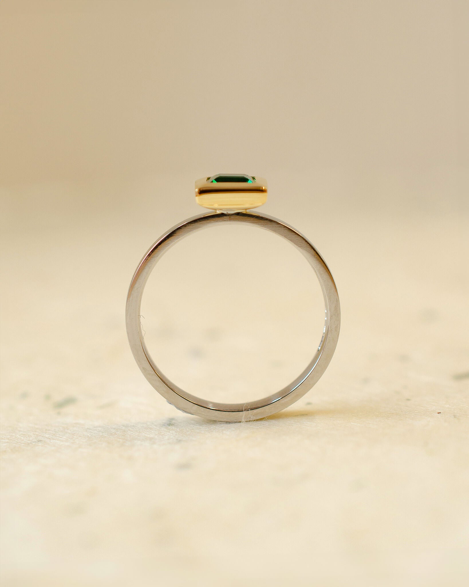 platinum and 18ct yellow gold ring with princess cut emerald