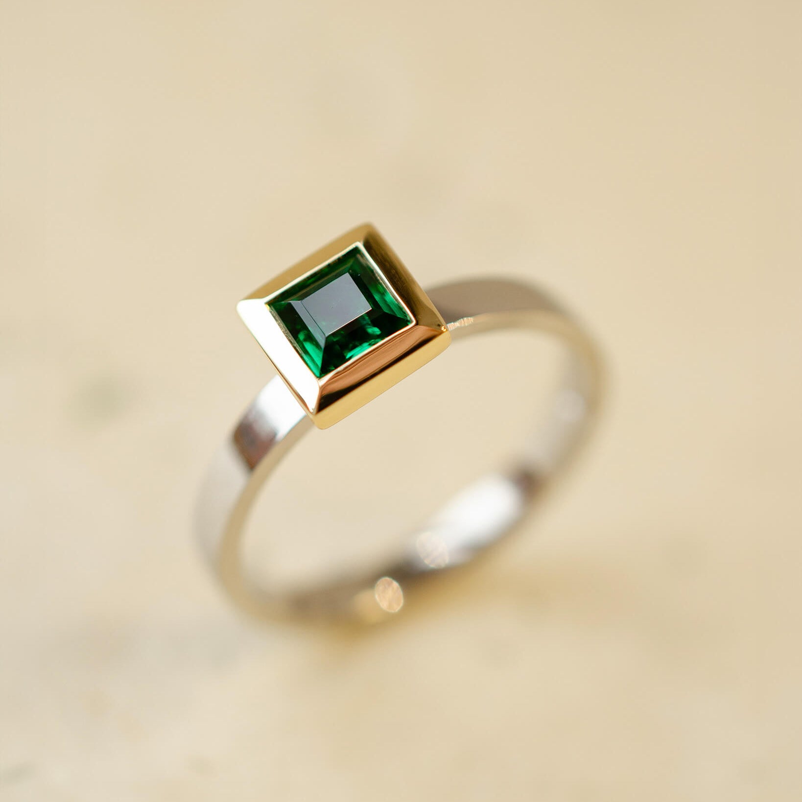 platinum and 18ct yellow gold ring with princess cut emerald
