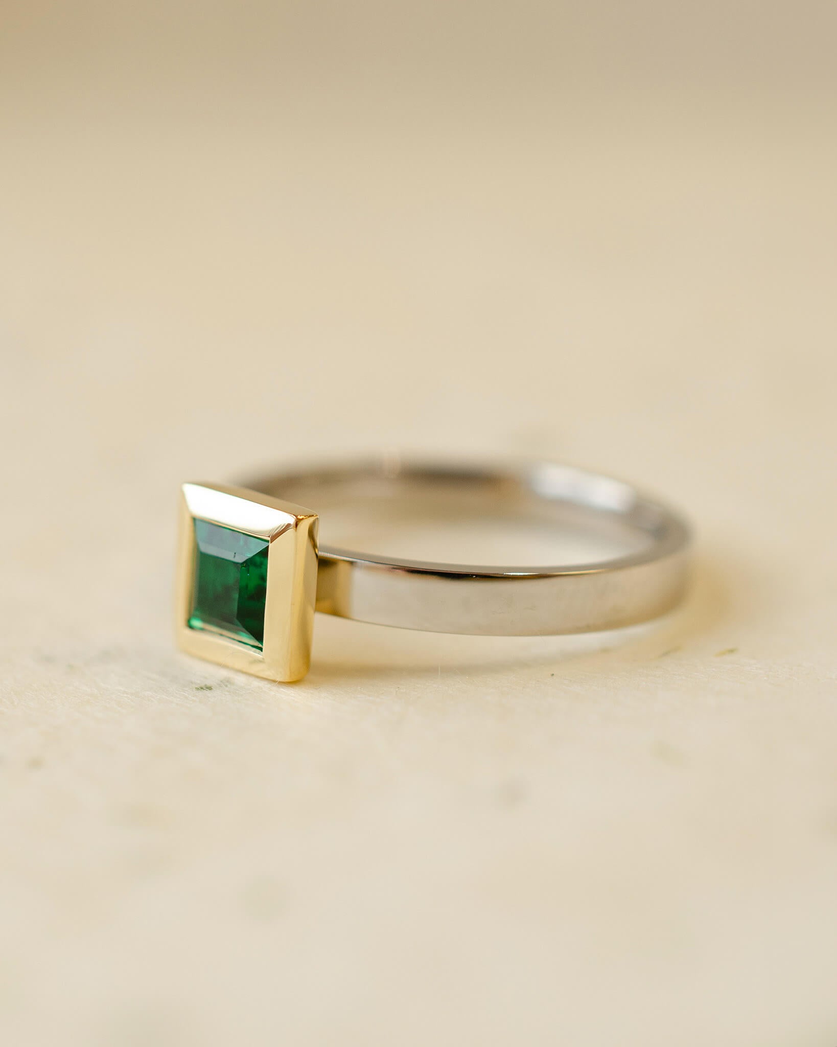 platinum and 18ct yellow gold ring with princess cut emerald