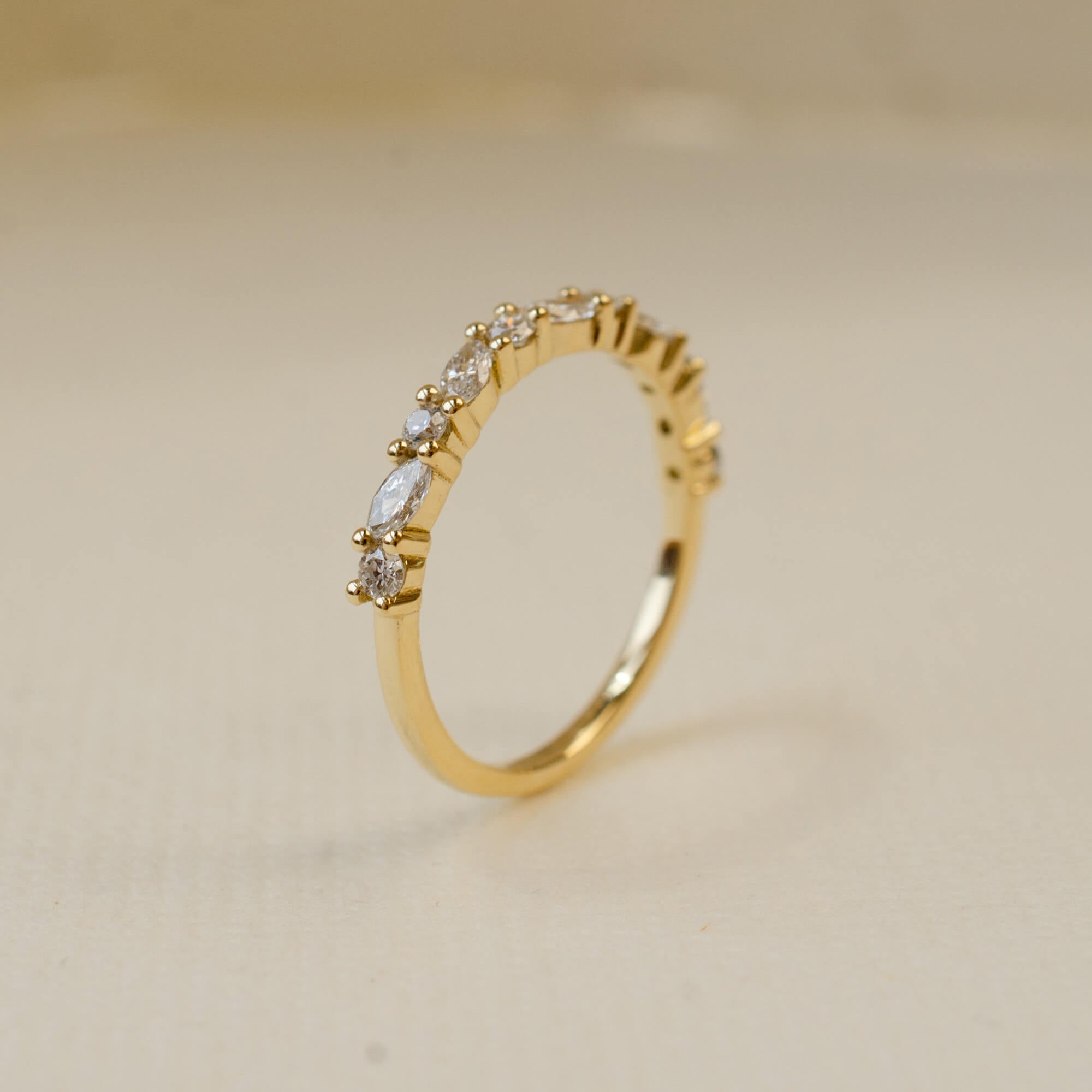 yellow gold wedding ring with round and marquise white diamonds