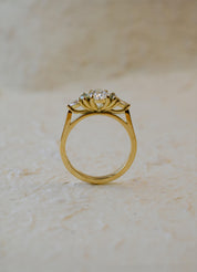 18ct yellow gold engagement ring with oval diamond and green marquise sapphires