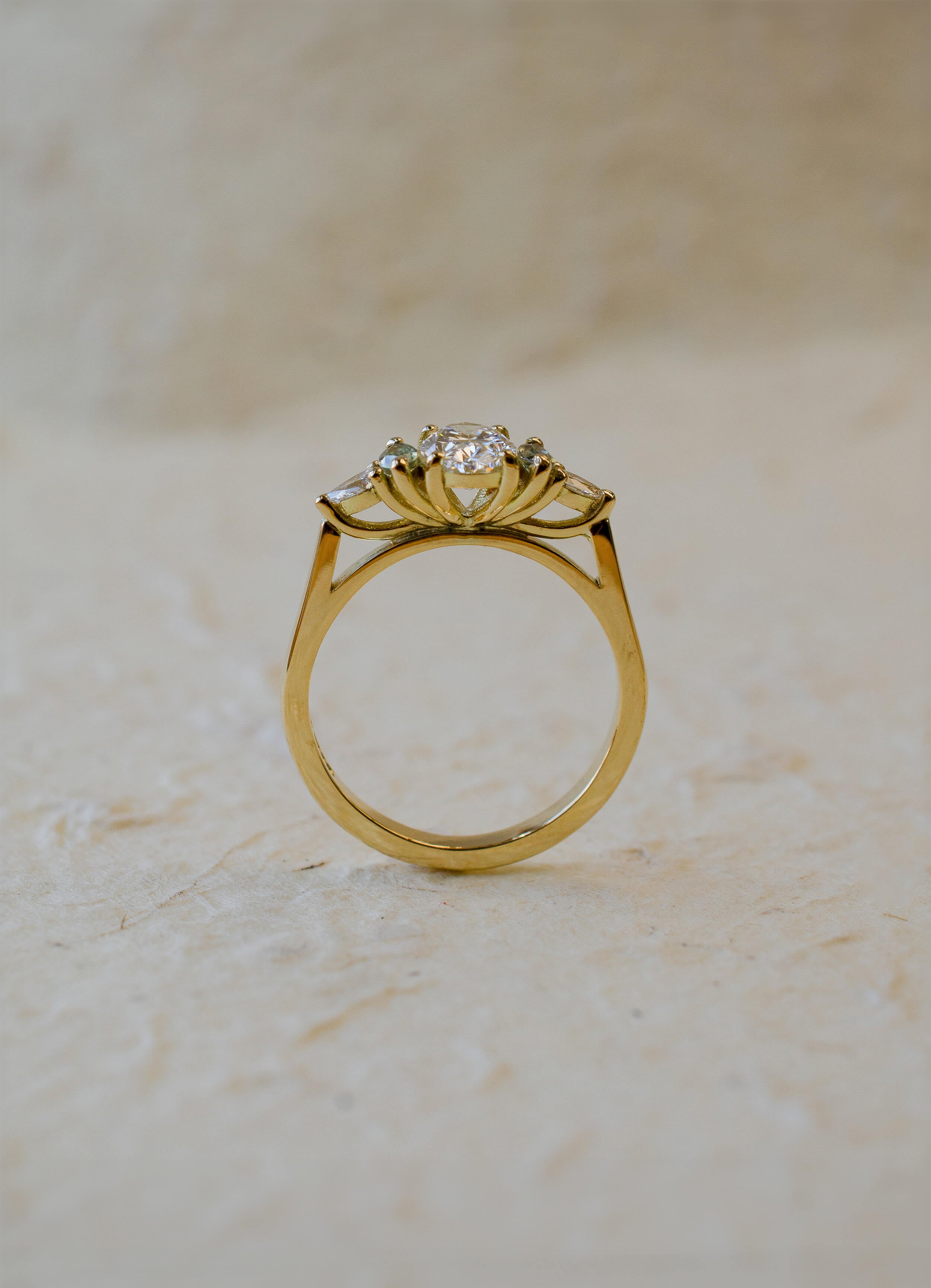 18ct yellow gold engagement ring with oval diamond and green marquise sapphires