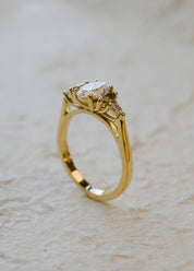 oval diamond engagement ring with marquise sapphire side stones