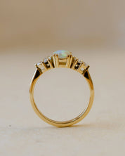 yellow gold ring with opal and diamond leaves on shoulders